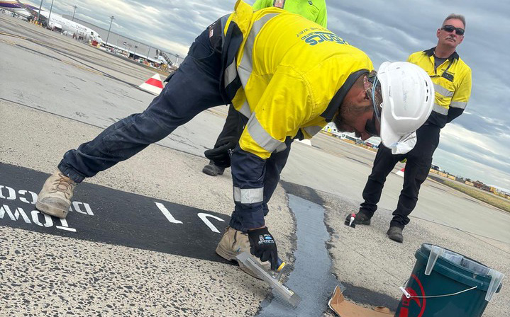 Sealant work on a roadway expansion joint
